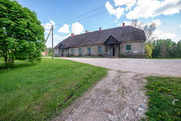 empty country gravel road with mud puddles and bumps