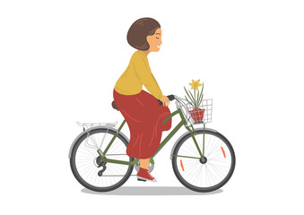 Cycling woman with daffodile flower in basket.