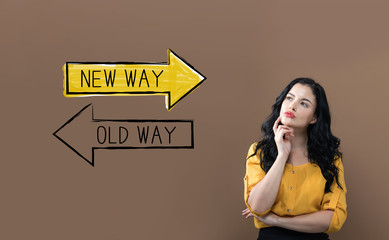 Old way or new way with young businesswoman on a brown background