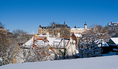Altenburg / Germany: View over the snowy city district of Naschhausen in the former residential town with the south view of the residence castle in the back on a beautiful winter day