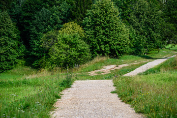 empty country gravel road with mud puddles and bumps