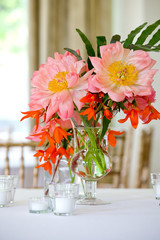 Pink and red bouquet of flowers on a table during a wedding event 