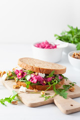 beetroot and feta cheese sandwich with walnuts and rocket