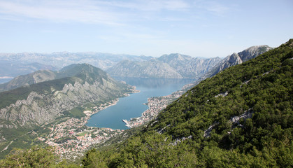 Fototapeta premium Panorama UNESCO World Heritage Site bay of Kotor with high mountains plunge into adriatic sea and Historic town of Kotor, Montenegro