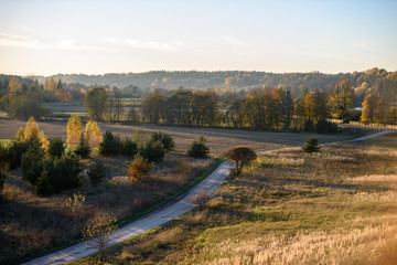 Obraz premium empty country gravel road with mud puddles and bumps