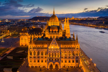 Fototapeta na wymiar Budapest, Hungary - Aerial blue hour view of the Parliament of Hungary with Buda Castle Royal Palace, Liberty Statue and ferris wheel at background