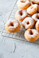 Bunch Of Donuts With Powdered Sugar On A Cooling Tray