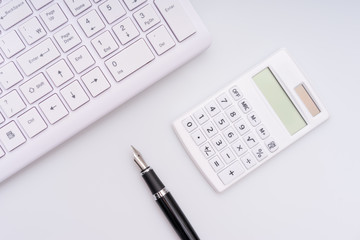  Calculator, computer keyboard and fountain pen