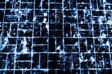 White snow on the black tiles