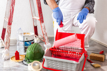 Professional house painter at work with the roller © francescomou