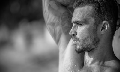 Portrait of a handsome caucasian male model posing on the beach
