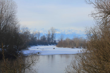 panorama of a river with snow in winter