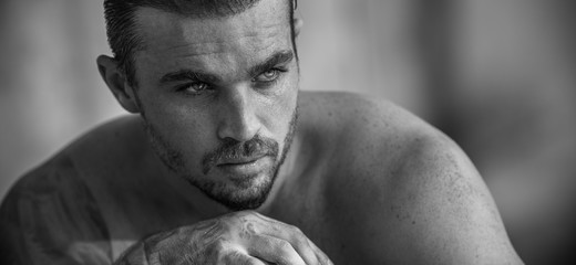 Portrait of a handsome caucasian male model posing on the beach