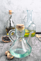 oil jugs with olive oil and black garlic in rustic gray setting