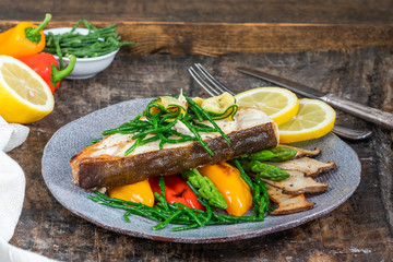 Grilled halibut steak with vegetables - sweet mini peppers, courgette, asparagus and oyster...