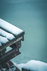 Snowy pier and frozen sea