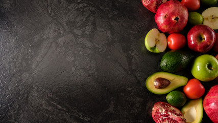 Healthy food. Vegetables and fruits. On a black background. Top view. Copy space..