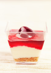 close up of chocolate cake with white cream flower and Chery, chocolate shavings