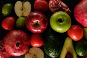 Healthy food. Vegetables and fruits. Measuring tape. On a black background. Top view.