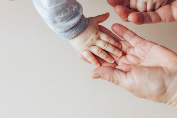 An old woman and a kid holding hands together