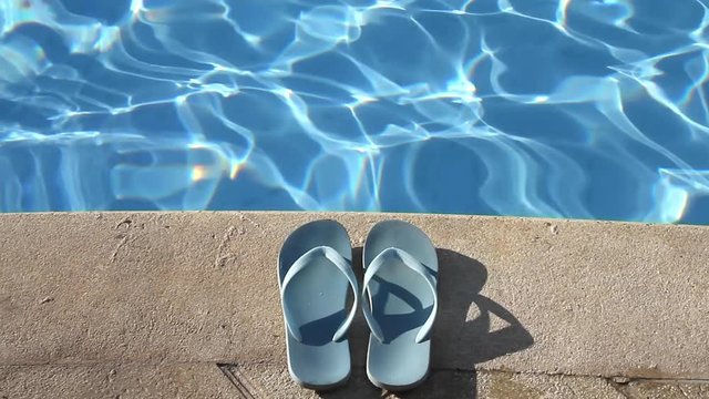 Pair of flip flops by the poolside - Summer vacation - Relaxing travel concept