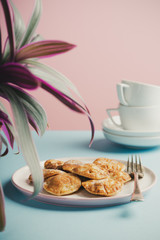 Dutch mini pancakes called poffertjes, sprinkled with powdered sugar. Healthy food concept with copy space. Toned photo.