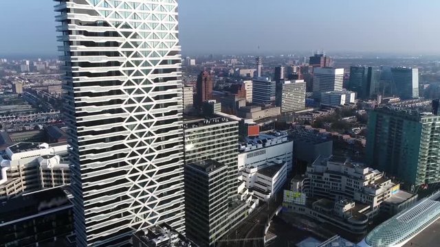 Aerial helicopter view moving past modern skyscraper located at downtown The Hague is city on the western coast of the Netherlands and the capital of the province of South Holland 4k high resolution
