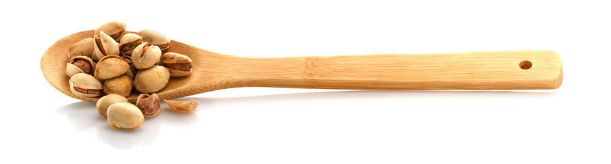 Pistachio, on a wooden spoon. Isolated on white background. Place for text.