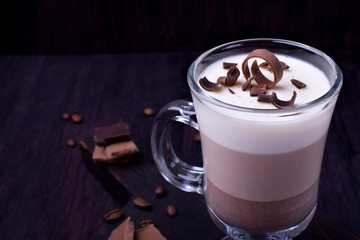 Layered dessert in an Irish glass mug with coffee and chocolate