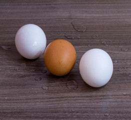 Three eggs on a wooden table diagonally