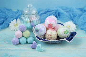 Handmade fragrant multicolored bath balls (bombs) and sugar scrub for hands. Selection focus on some balls.