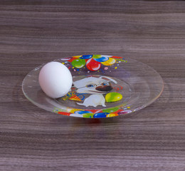 One white egg on a plate