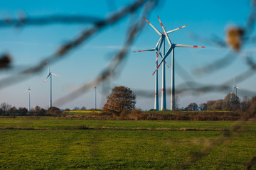 Wind Turbines sit on rolling hills. Wind turbine field generate of electrical