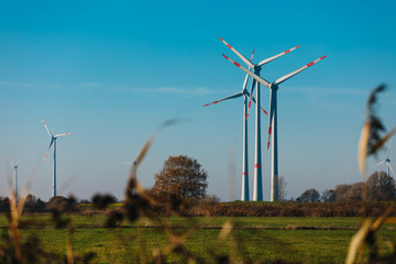 Wind Turbines sit on rolling hills. Wind turbine field generate of electrical