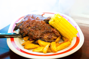 Grilled steak - Grilled meat ribs on the plate with hot sauce