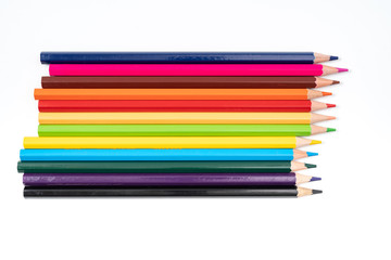 Fototapeta premium Colored pencils in a row isolated on white background.