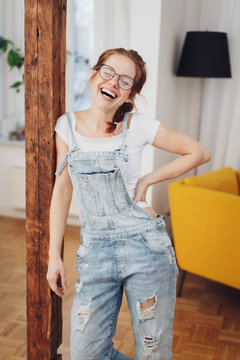 Cute young girl in denim overalls, laughing