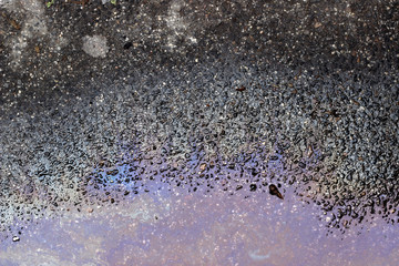 Oil spill wet asphalt pavement texture surface