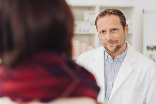 Concerned pharmacist listening to a client