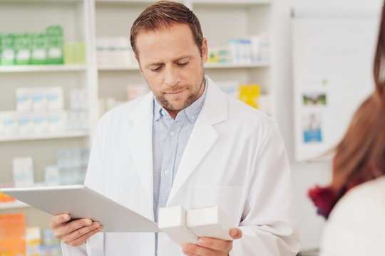 Pharmacist checking medicines before dispensing