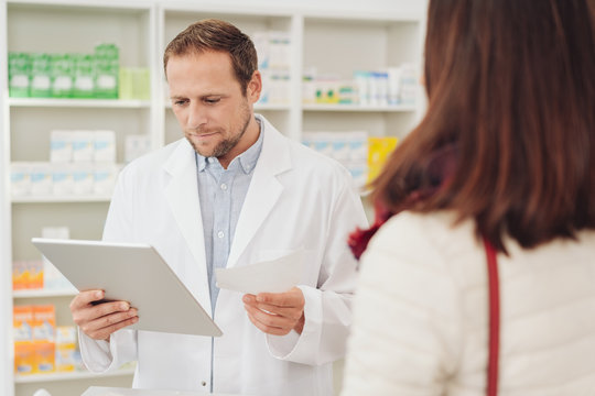 Pharmacist checking a script for a patient