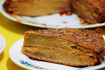 Honey cake on a plate on a yellow background