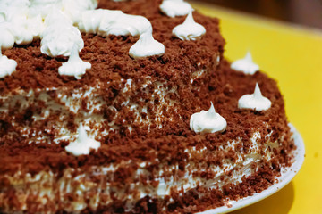 Chocolate cake decorated with white cream