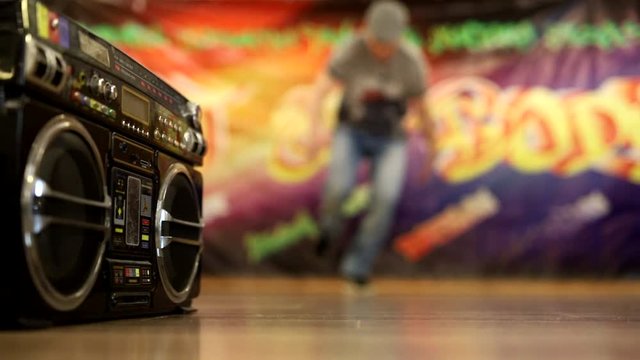 leg work in dance with a boombox, fuzzy picture, place for text, breakdancer in action