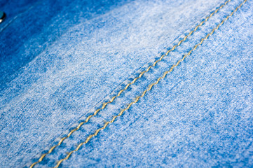 Blue washed faded jeans texture with seams
