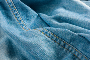 Blue washed faded jeans texture with seams