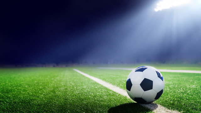 Tradition soccer ball illuminated by stadium lights