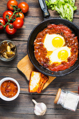 Shakshuka, Fried Eggs in Tomato Sauce in iron frying pan. Typical Israel food.