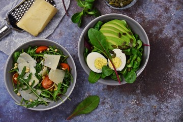 Two fresh salads bowls isolated on dark background. Flat lay salad bowls