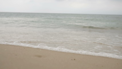 Sea waves over the sandy beach Festive background